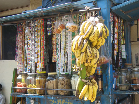 Shop seller hidden by bags